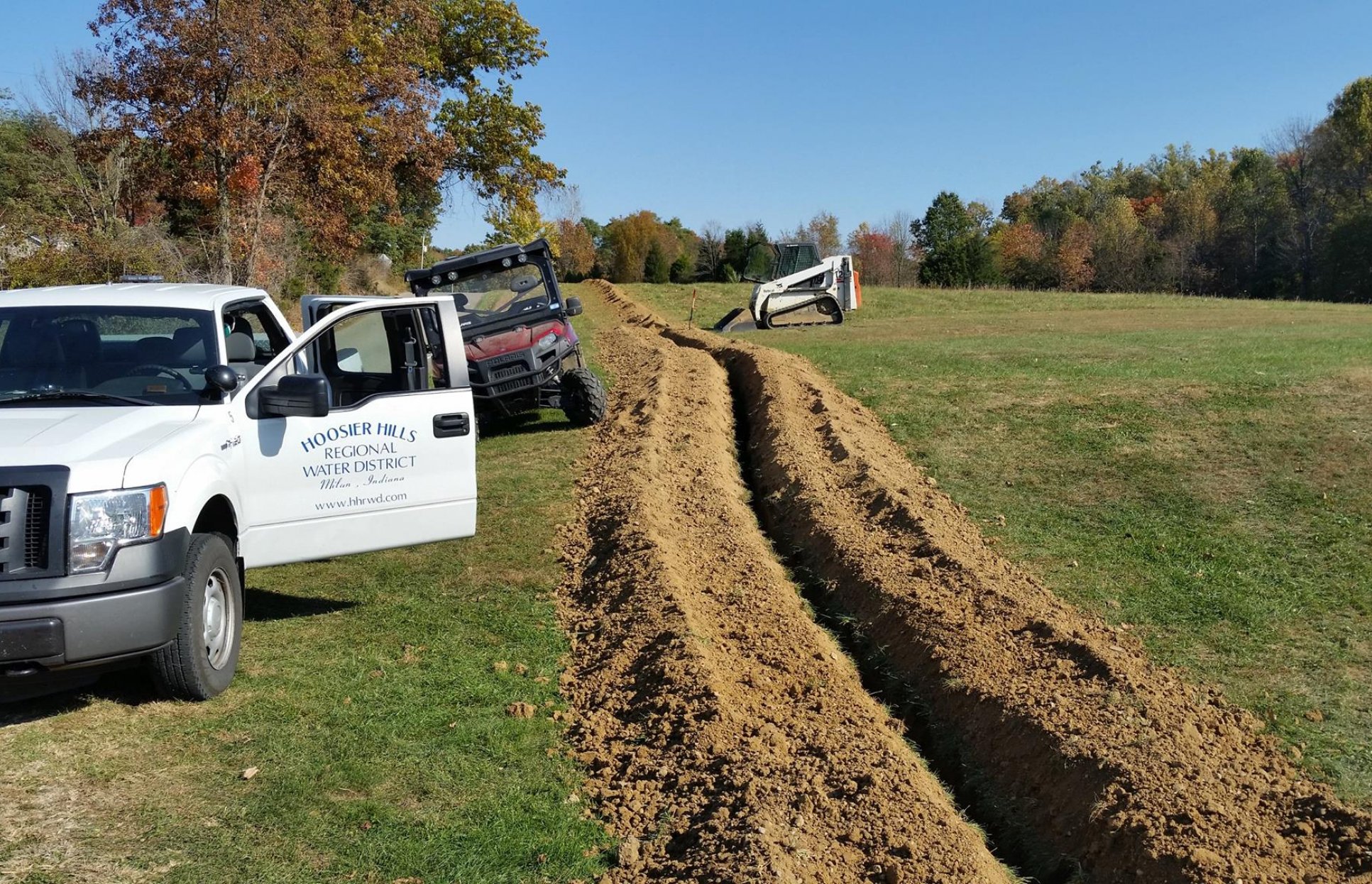 a truck next to a newly dug trench